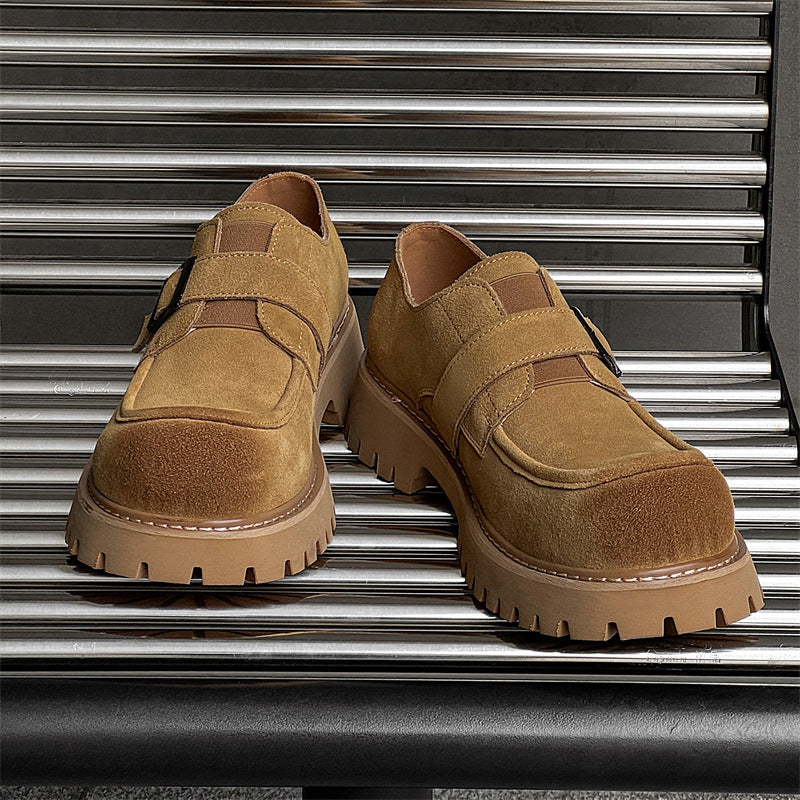 Pair of brown shoes on a metallic surface