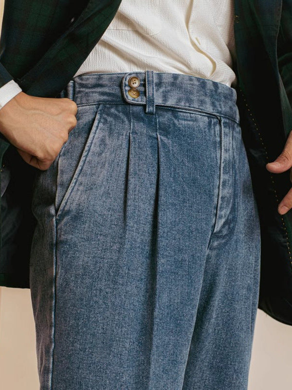 Close-up of blue pleated pants with a beige background