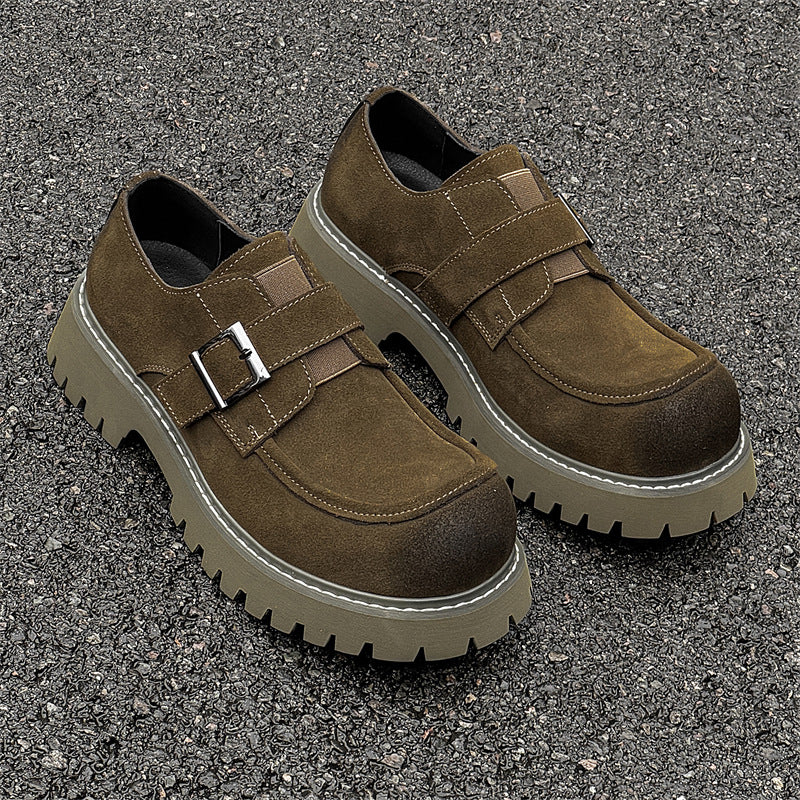 Brown shoes with velcro straps on a textured surface